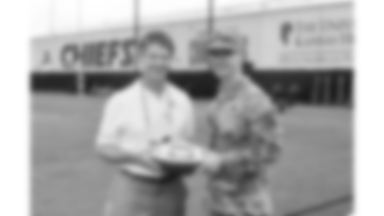 Kansas City Chiefs Chairman, CEO, and Owner Clark Hunt presents a ball to service member of the Whiteman U.S. Air Force base during day 1 of the Kansas City Chiefs Season Ticket Member First Look Event on Tuesday June 17, 2025 in Kansas City, MO.