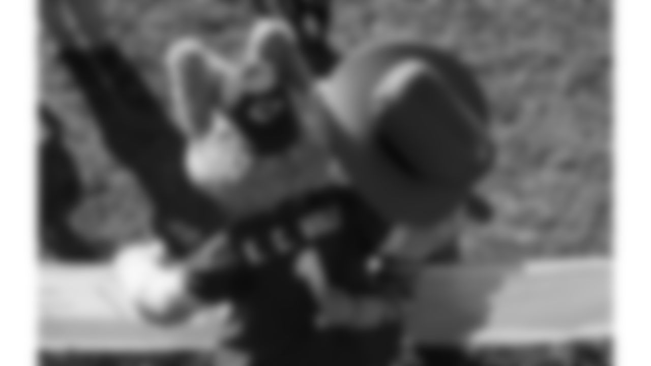 KC wolf poses with Texas Roadhouse Mascot Andy Armadillo during day 17 of Training Camp practice on Wednesday, August 13, 2025.