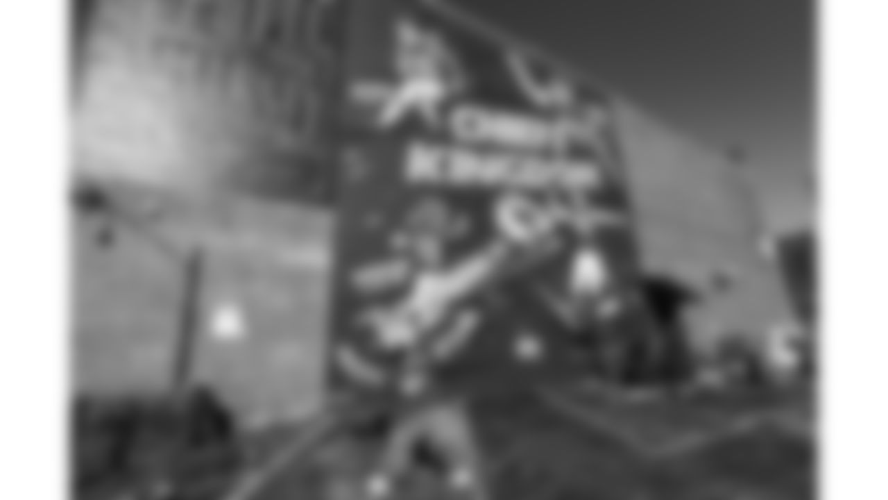 KC Wolf poses in front of a Chiefs mural displayed on the side of Tom's Town Distilling at East 17th and Main on January 21, 2021 in Kansas City, Missouri.