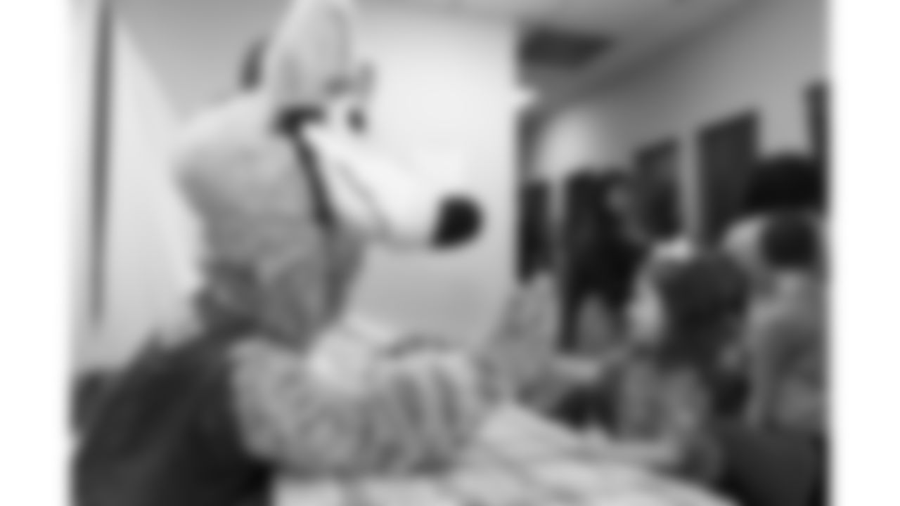 KC Wolf plays with kids before the reveal of cornerback Trent McDuffies (22) My Cause My Cleats at the Solace House in Shawnee Mission, Kansas on Tuesday, November 11, 2025.