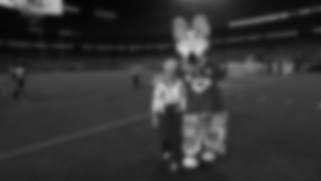 Coin toss captain Madelyn Bowden walks off the field with KC Wolf prior to a week 6 NFL Football game against the Detroit Lions on Sunday, October 12, 2025 in Kansas City, MO.
