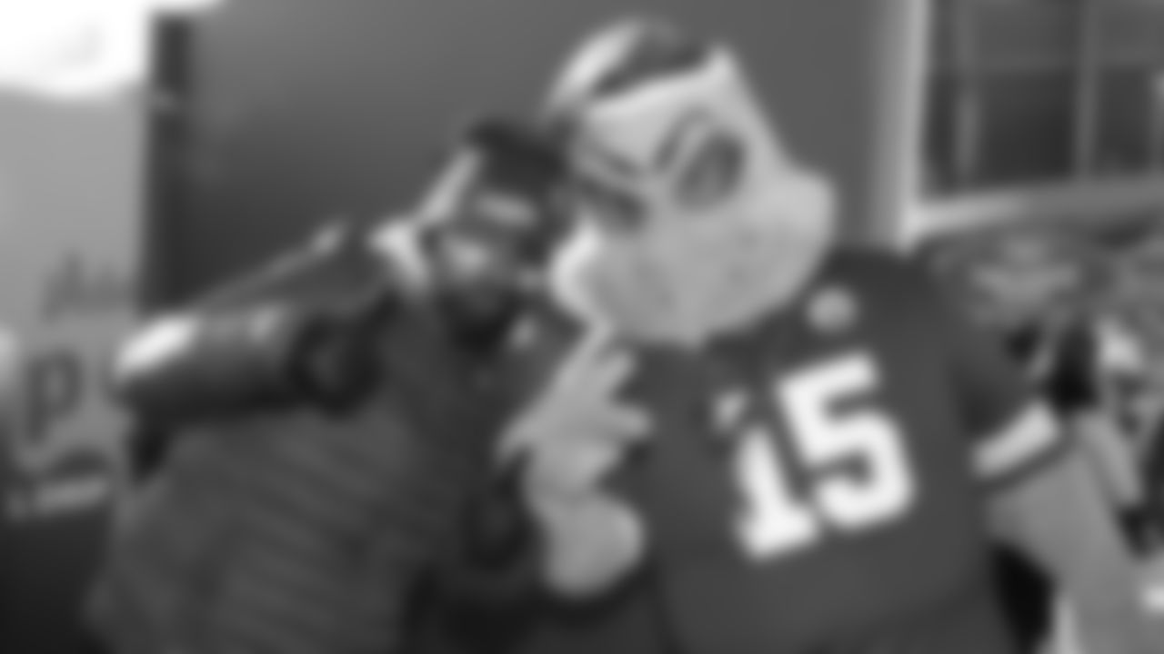 The Grinch with a fan prior to an NFL week 15 matchup against the Los Angeles Chargers, Sunday December 14, 2025.