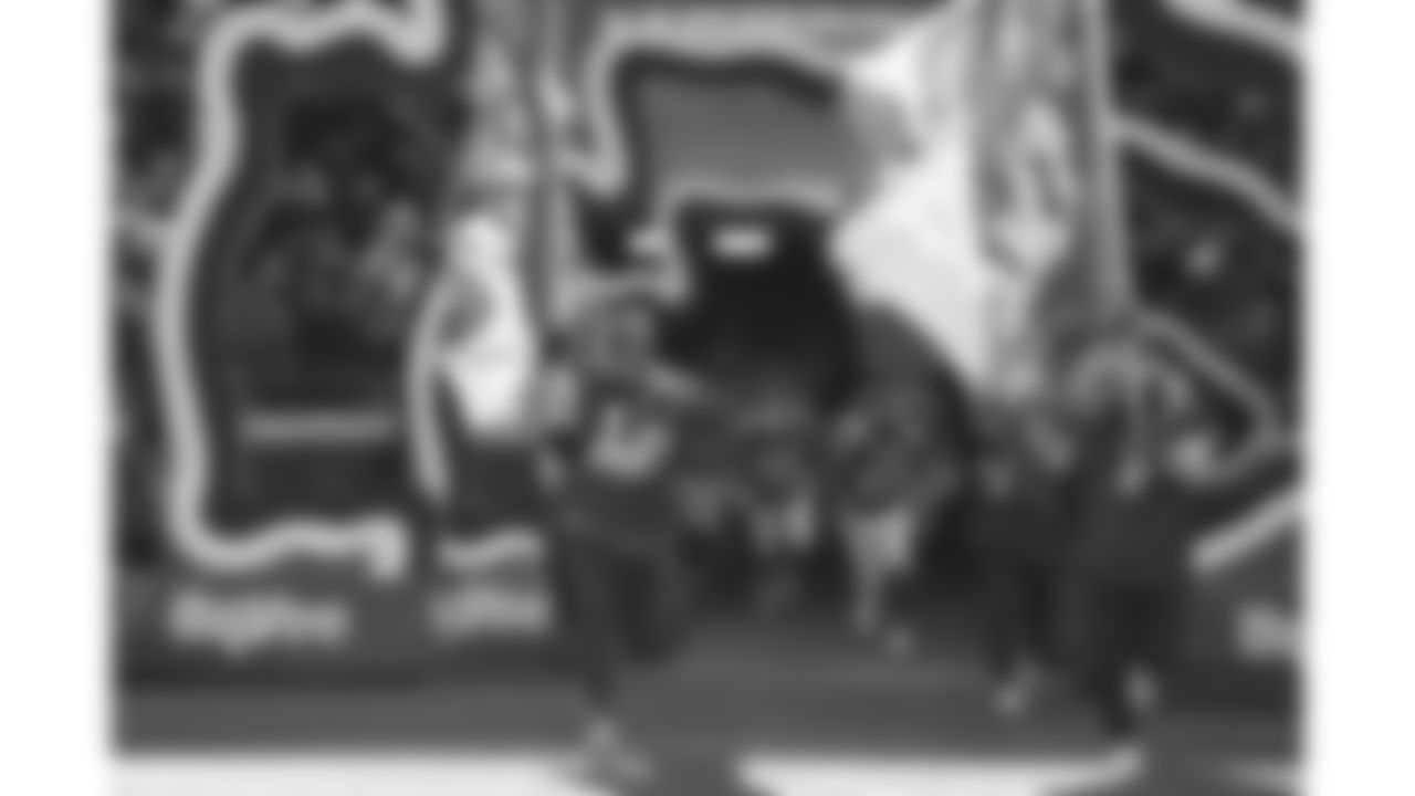 Chiefs Flag Runners enter the field prior to a week 15 NFL Football game against the Los Angeles Chargers on Sunday, December 14, 2025 in Kansas City, MO.