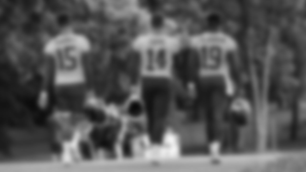 The quarterbacks walking down the hill to training camp on day 1 of practice, Tuesday July 22, 2025