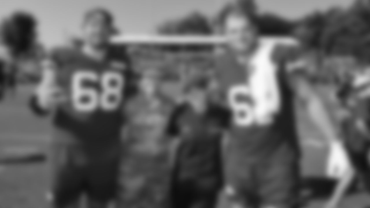 U.S. service members pose with Kansas City Chiefs offensive linemen Joey Lombard (68) and C.J. Hanson (61) while attending Military Appreciation Day during day 17 of Training Camp practice on Wednesday, August 13, 2025.