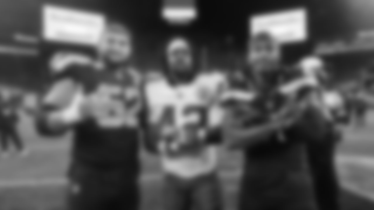 Kansas City Chiefs safety Major Williams (42) poses for a photo with Seattle Seahawks center Federico Maranges (62) and cornerback Keydrain Calligan (17) following a preseason week 2 NFL football game, Friday, August 15, 2025 in Seattle, WA.
