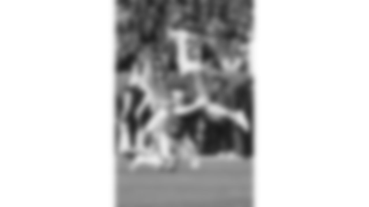 Kansas City Chiefs running back Kareem Hunt (29) leaps over a Broncos defender during a week 11 NFL Football game against the Denver Broncos on Sunday, November 16, 2025 in Denver, Colorado.