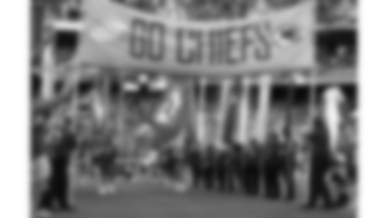 Kansas City Chiefs Red Coaters hold the introduction flags prior to a preseason week 3 NFL football game against the Chicago Bears on August 22, 2025 in Kansas City, MO.