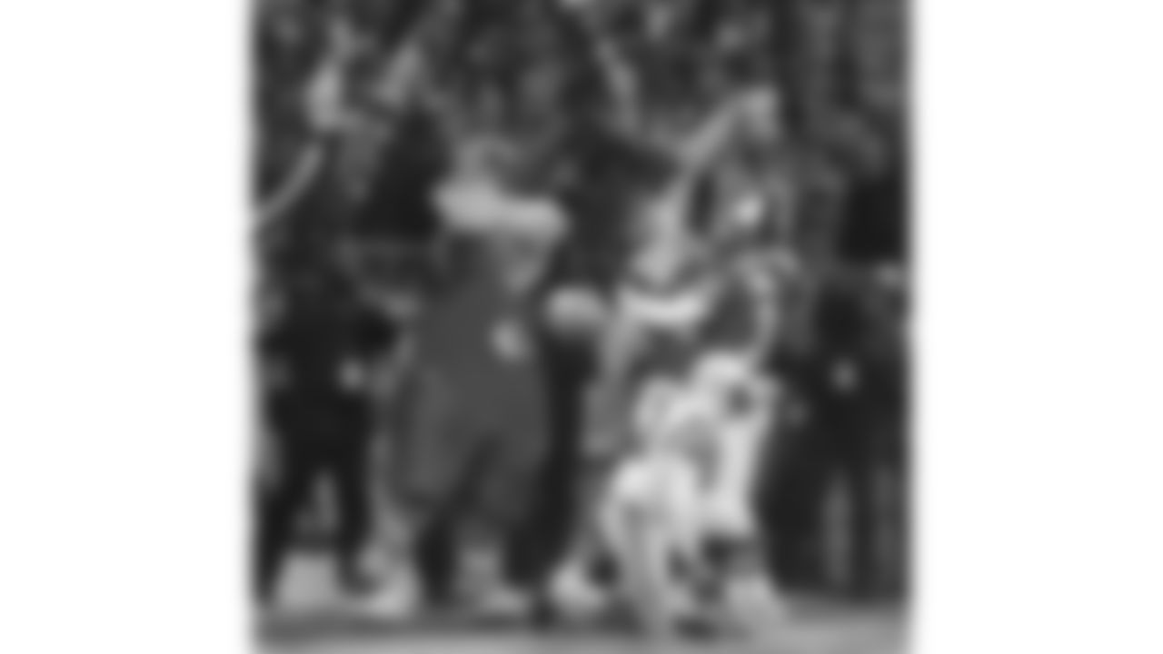 Kansas City Chiefs cornerback Sean Crocker (31) celebrates in the end zone with a teammate and KC Wolf during the Jan. 7 1996 AFC Divisional home playoff game against the Indianapolis Colts.