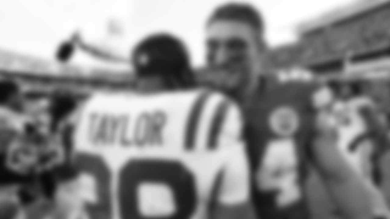 Kansas City Chiefs linebacker Leo Chenal (54) hugs Indianapolis Colts running back Jonathan Taylor (28) after a week 12 NFL Football game against the Indianapolis Colts on Sunday, November 23, 2025 in Kansas City, MO