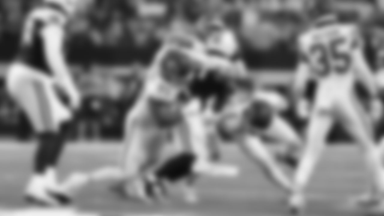 Kansas City Chiefs defensive lineman Jerry Tillery (99) and Kansas City Chiefs safety Bryan Cook (6) make a tackle during a week 13 NFL football game against the Dallas Cowboys on Thursday, November 27, 2025 in Arlington, TX.