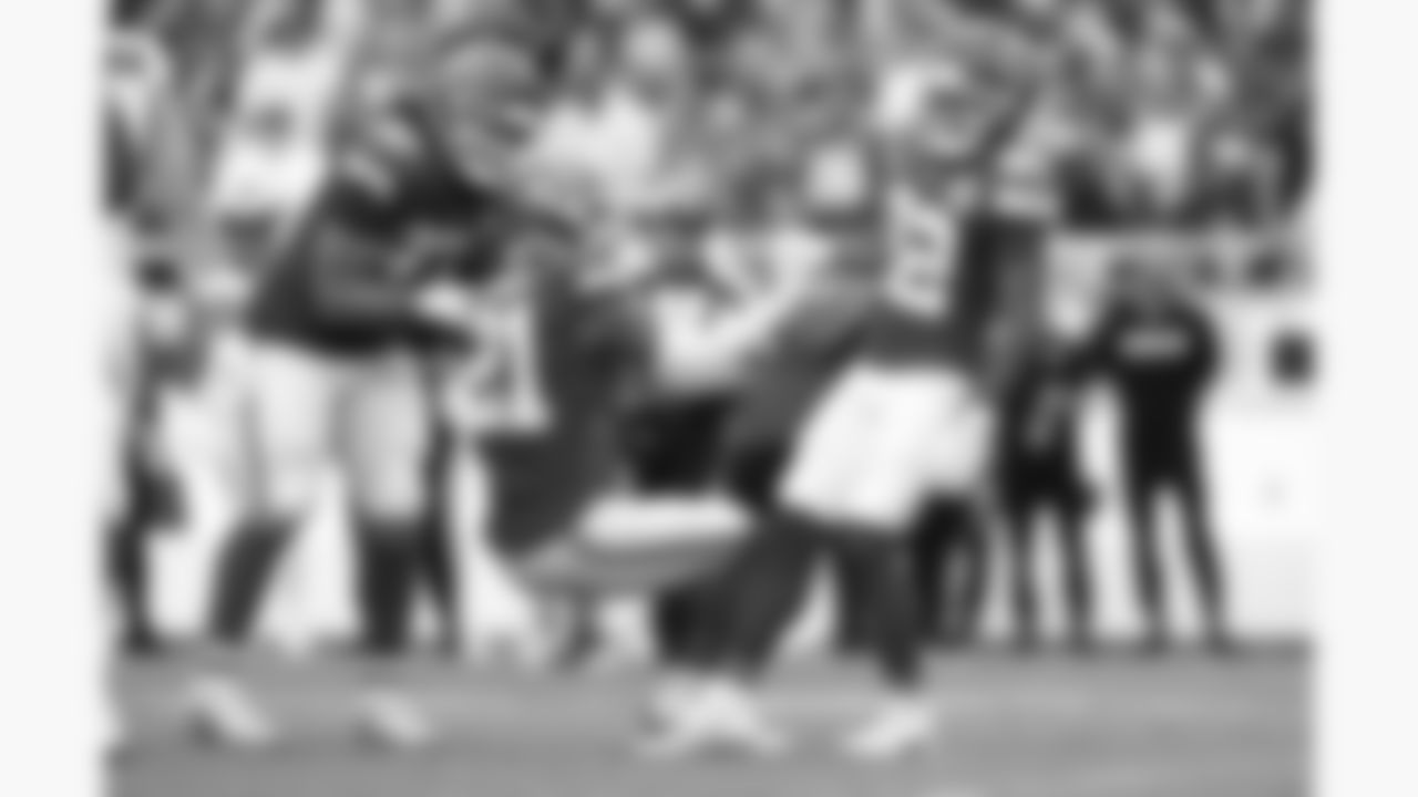 Kansas City Chiefs cornerback Trent McDuffie (22) and defensive end Ashton Gillotte (97) help defensive back Jaden Hicks (21) up during the week 2 NFL football game against the Philadelphia Eagles, Sunday, September 14, 2025 in Kansas City, MO.