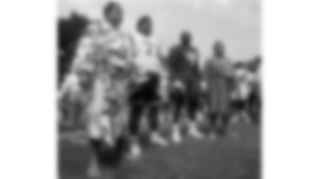 Kansas City Chiefs defensive end Neil Smith (90) and sumo wrestlers stand on the field during a 1994 preseason practice in Tokyo, Japan.