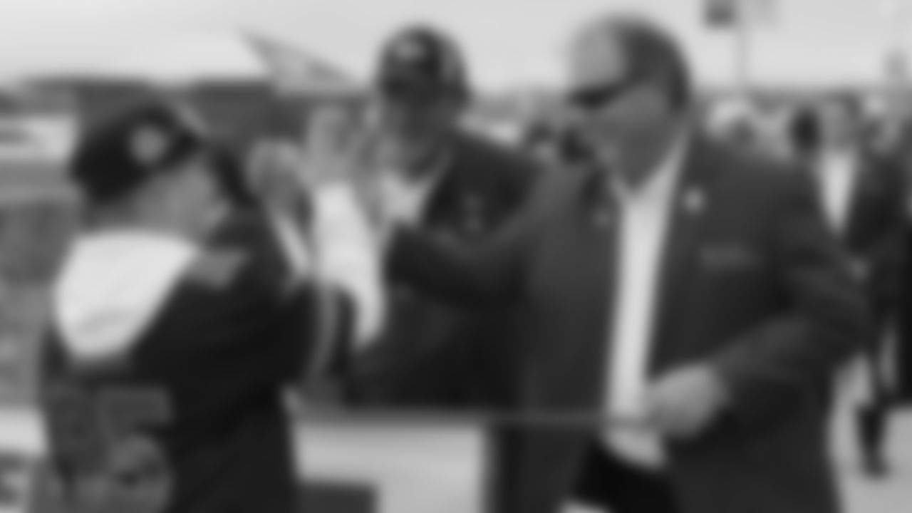 The Red Coaters and a fan before a week 12 NFL football game against the Indianapolis Colts, Sunday, November 23, 2025 in Kansas City, MO.