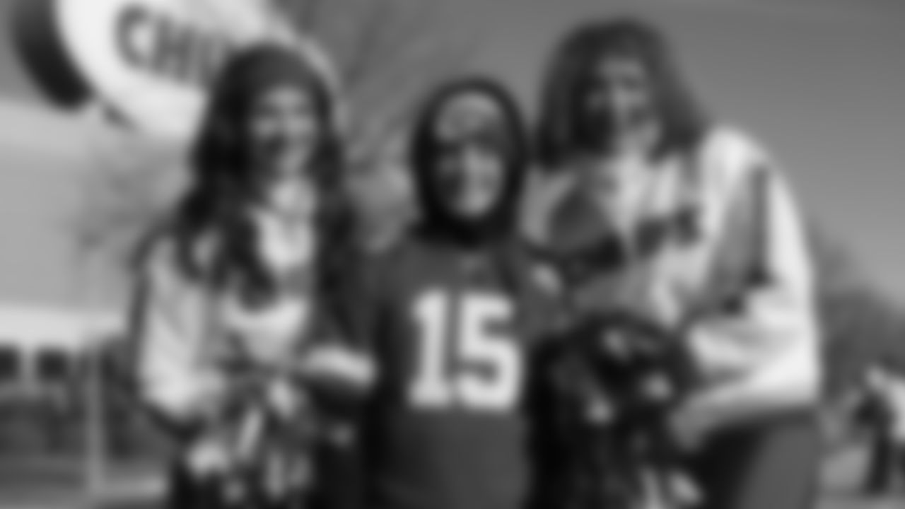 Kansas City Chiefs Cheerleaders pose with a fan prior to a week 15 NFL Football game against the Los Angeles Chargers on Sunday, December 14, 2025 in Kansas City, MO.