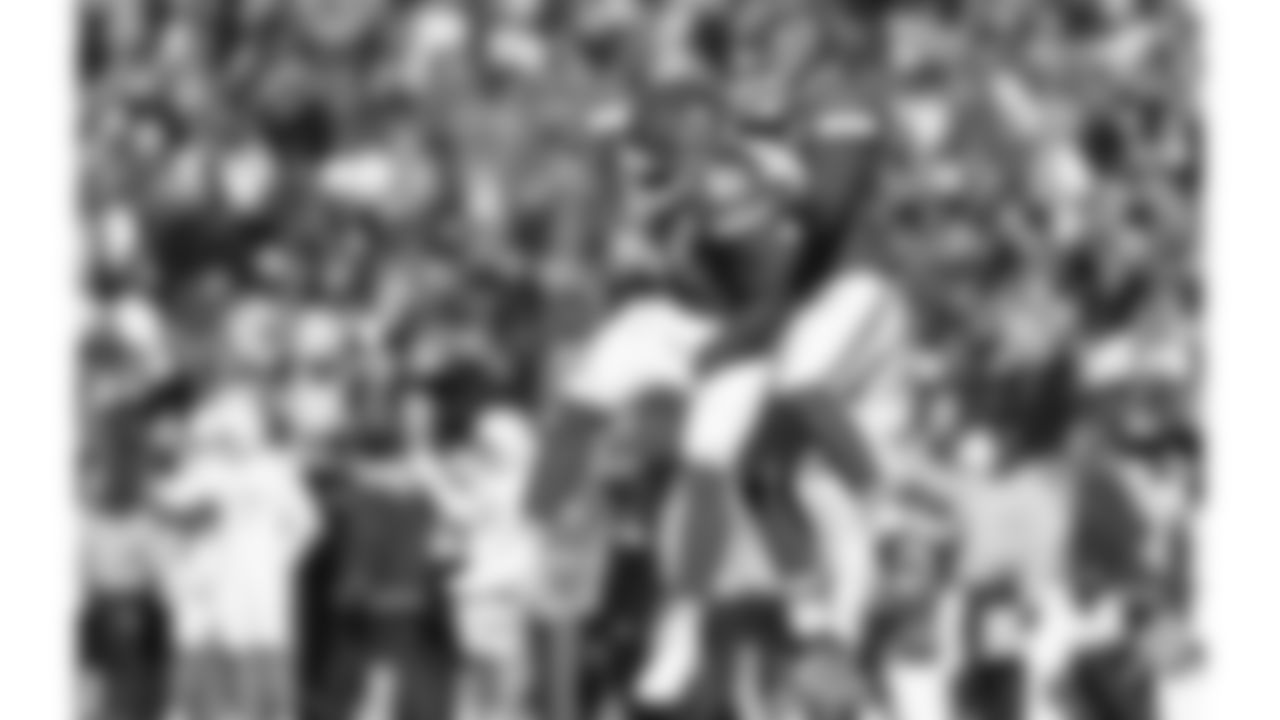 Kansas City Chiefs defensive end Mike Danna (51) and Kansas City Chiefs defensive end George Karlaftis (56) celebrate during an NFL week 15 matchup against the Los Angeles Chargers, Sunday December 14, 2025.