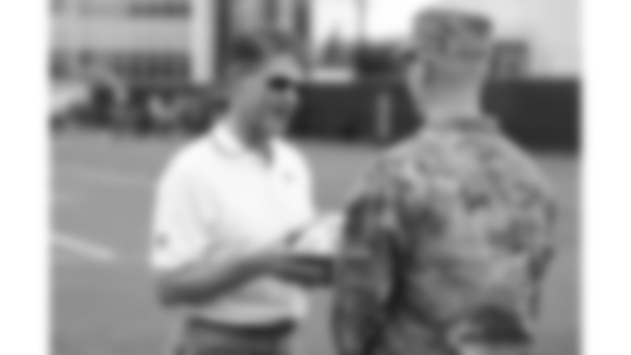 Kansas City Chiefs Chairman, CEO, and Owner Clark Hunt presents a ball to a service member from the Whiteman U.S. Air Force Base during day 1 of the Season Ticket Member First Look Event on Tuesday June 17, 2025 in Kansas City, MO.