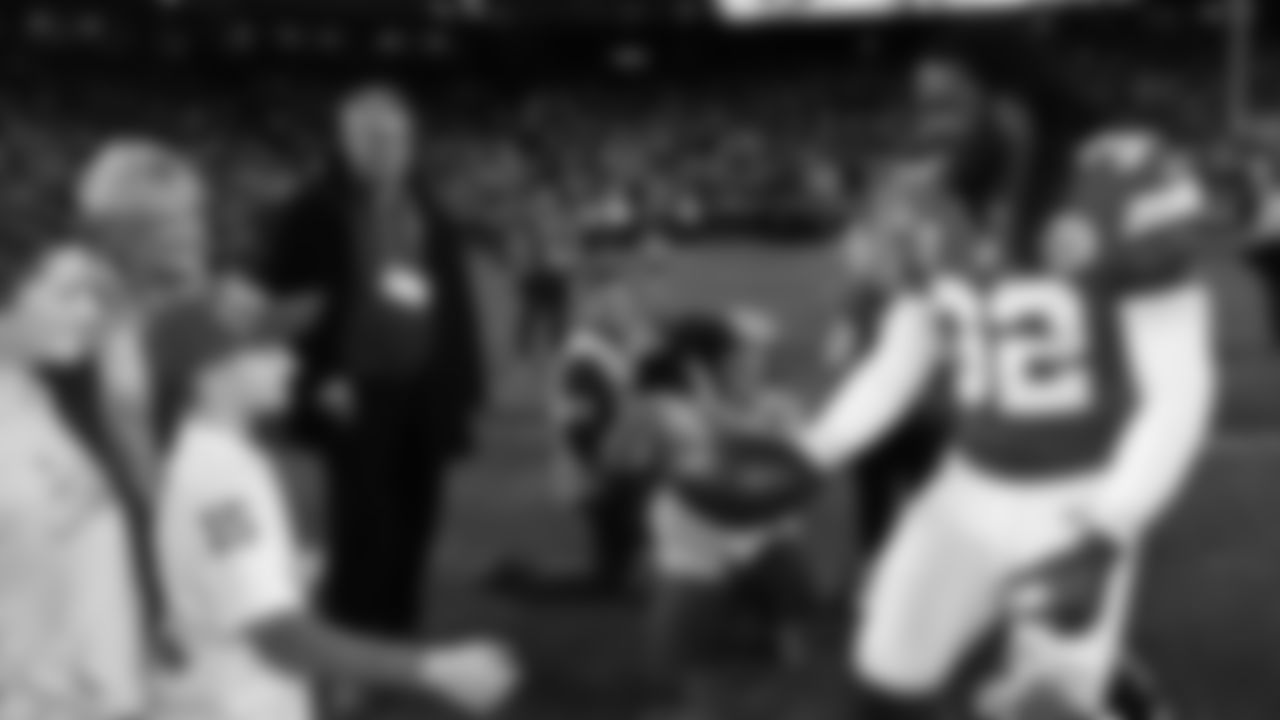 Kansas City Chiefs linebacker Nick Bolton (32) hands the game ball to the Kingdom Champ - Steven Ijams prior to an NFL week 17 matchup against the Denver Broncos, Thursday, December 25, 2025.