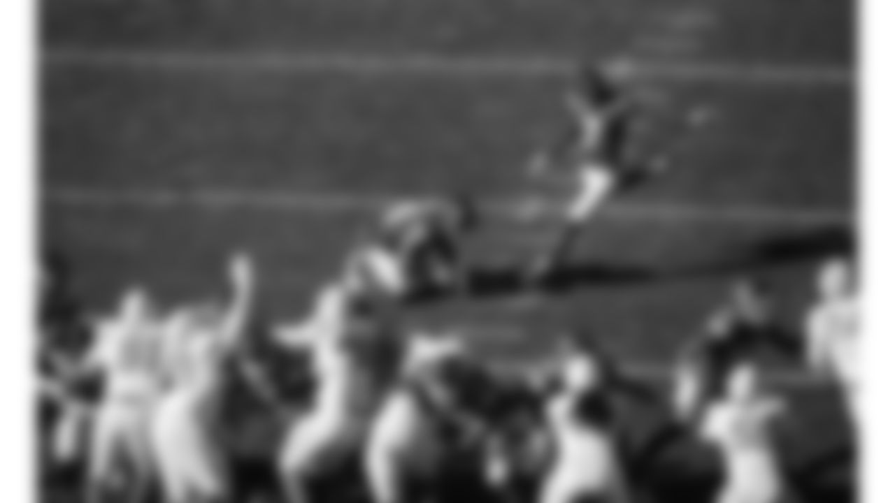Kansas City Chiefs punter Matt Araiza (14) holds the ball while kicker Harrison Butker (7) kicks a field goal during a week 15 NFL football game against the Los Angeles Chargers, Sunday, December 14, 2025 in Kansas City, MO.