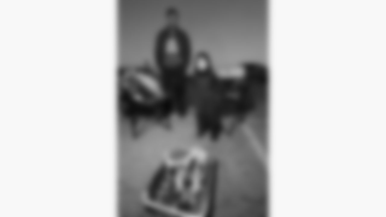 A young Kansas City Chiefs fan warms up by a fire in the parking lot prior to a week 14 NFL football game against the Houston Texans, Sunday, December 7, 2025 in Kansas City, MO.