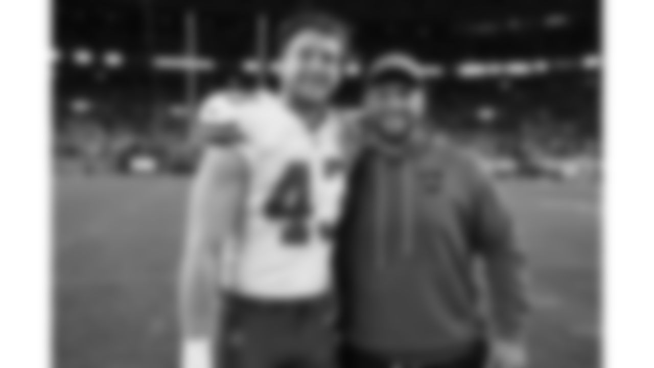 Kansas City Chiefs linebacker Jack Cochrane (43) and a Broncos coaching staff member after a week 11 NFL Football game against the Denver Broncos on Sunday, November 16, 2025 in Denver, Colorado.