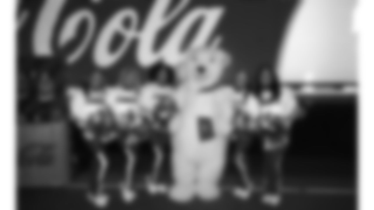 Kansas City Chiefs Cheerleaders pose with the Coca-Cola polar bear at the Ford Tailgate District prior to a week 14 NFL Football game against the Houston Texans on Sunday, December 7, 2025 in Kansas City, MO.