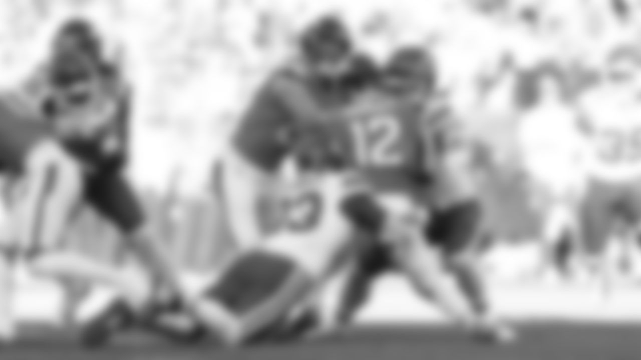 Kansas City Chiefs middle linebacker Drue Tranquill (23) and linebacker Leo Chenal (54) tackle a Broncos running back during a week 11 NFL Football game against the Denver Broncos on Sunday, November 16, 2025 in Denver, Colorado.