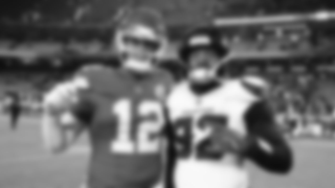 Kansas City Chiefs tight end Jared Wiley (12) poses with Houston Texans defensive end Dylan Horton (92) after an NFL week 14 matchup against the Houston Texans, Sunday December 7, 2025.