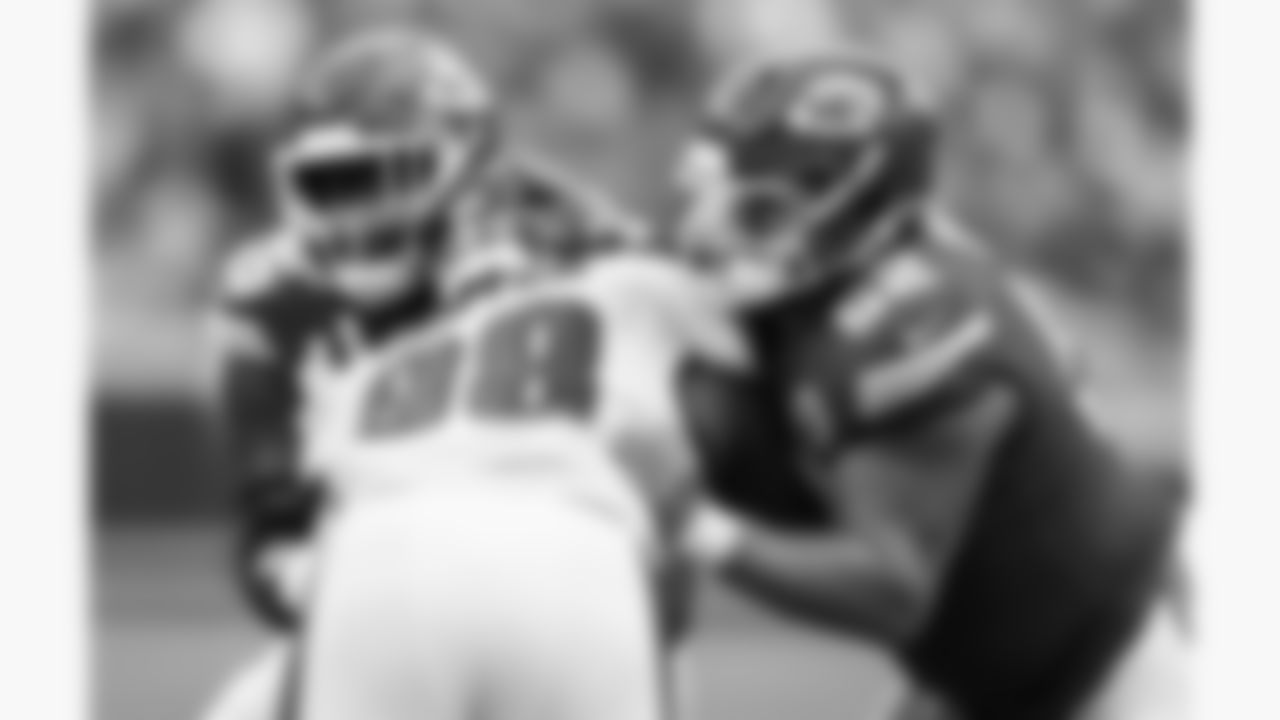 Kansas City Chiefs offensive lineman Trey Smith (65) and center Creed Humphrey (52) block Philadelphia Eagles defensive tackle Jalen Carter (98) during the week 2 NFL football game, Sunday, September 14, 2025 in Kansas City, MO.