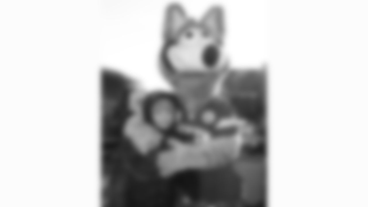 KC Wolf poses with fans in the Ford Tailgate District prior to a week 15 NFL Football game against the Los Angeles Chargers on Sunday, December 14, 2025 in Kansas City, MO.