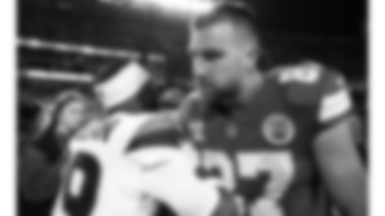 Kansas City Chiefs tight end Travis Kelce (87) talks with Denver Broncos running back Jaquan McMillian (29) after an NFL week 17 matchup against the Denver Broncos, Thursday, December 25, 2025.