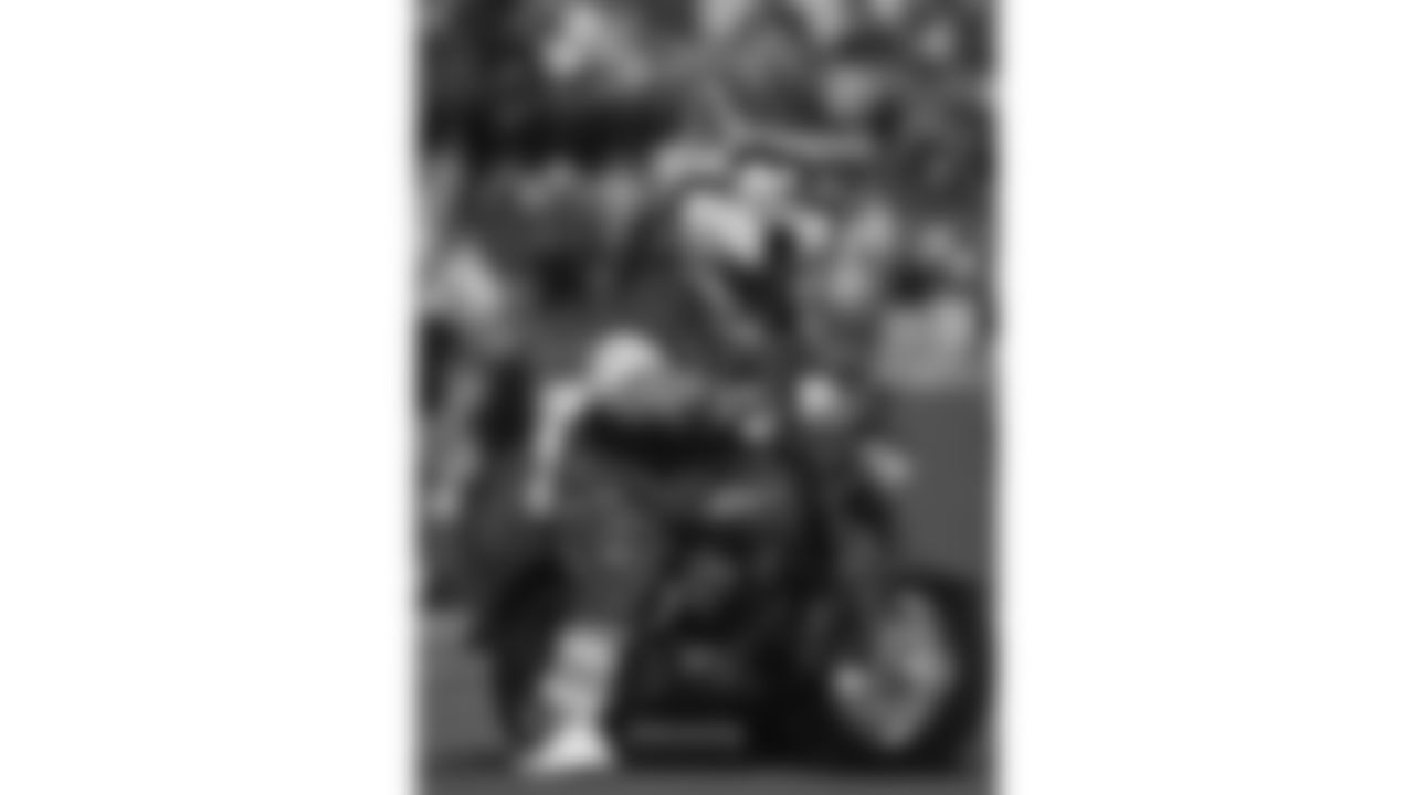 KC Wolf rides a motorcycle on the field during a 1994 NFL game.