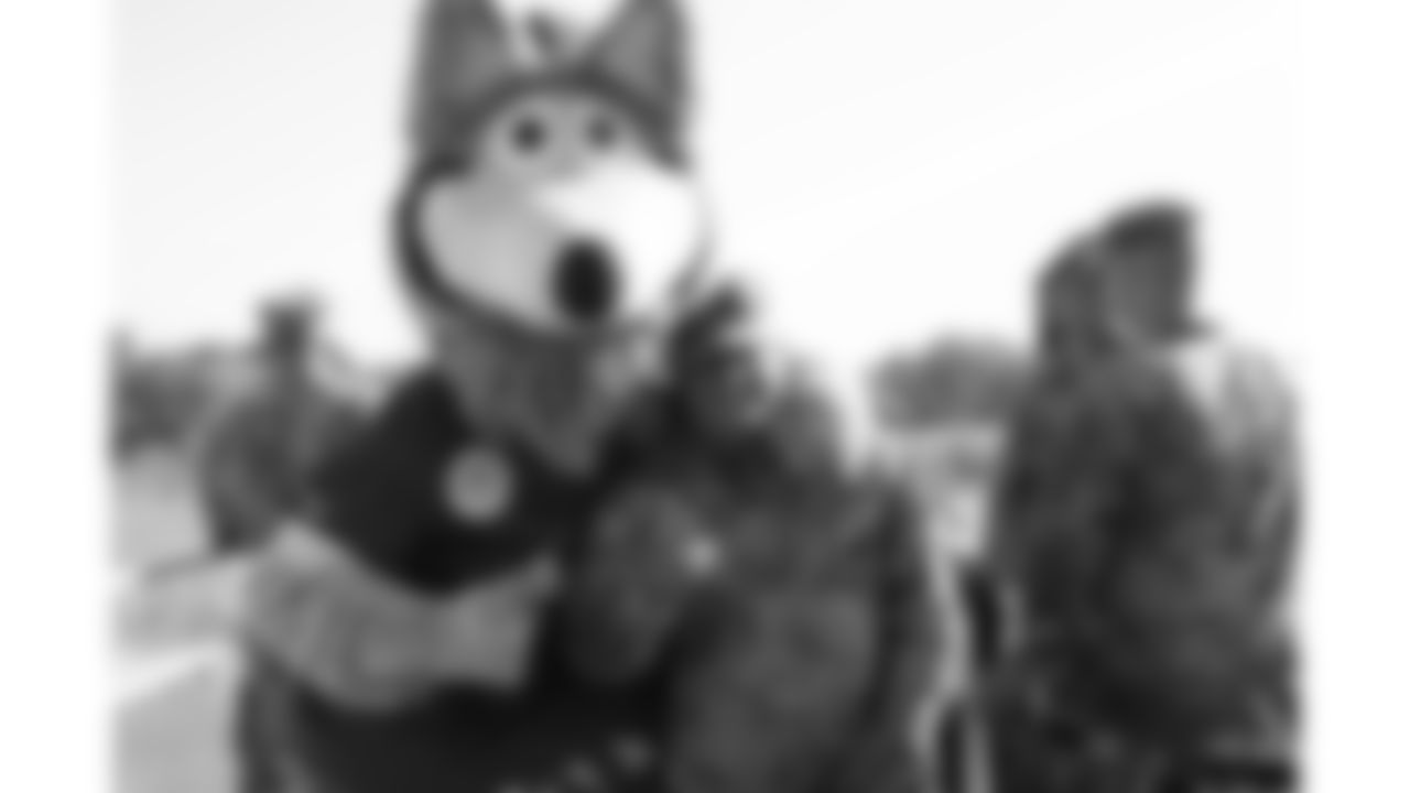 KC wolf poses with U.S. service members attending Military Appreciation Day during day 17 of Training Camp practice on Wednesday, August 13, 2025.
