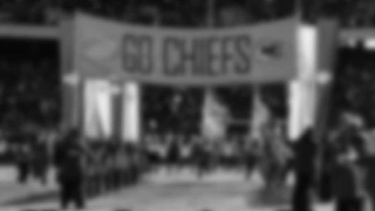 Chiefs Flag Runners enter the field prior to a week 15 NFL Football game against the Los Angeles Chargers on Sunday, December 14, 2025 in Kansas City, MO.
