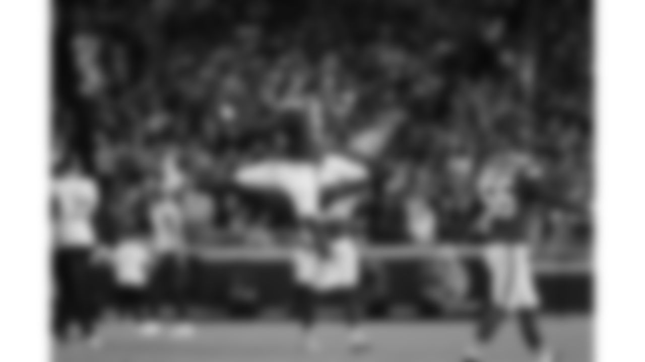 Kansas City Chiefs defensive end Mike Danna (51) and defensive back Jaden Hicks (21) jump to celebrate a sack during a week 8 NFL Football game against the Washington Commanders on Monday, October 27, 2025 in Kansas City, MO.