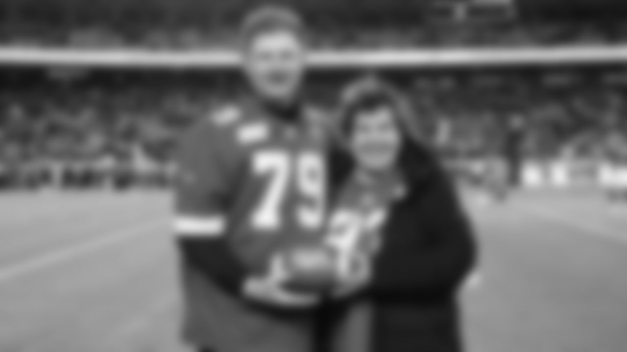 Legend: Dave Szott with Paula Pratt for the First Pass prior to an NFL week 14 matchup against the Houston Texans, Sunday December 7, 2025.