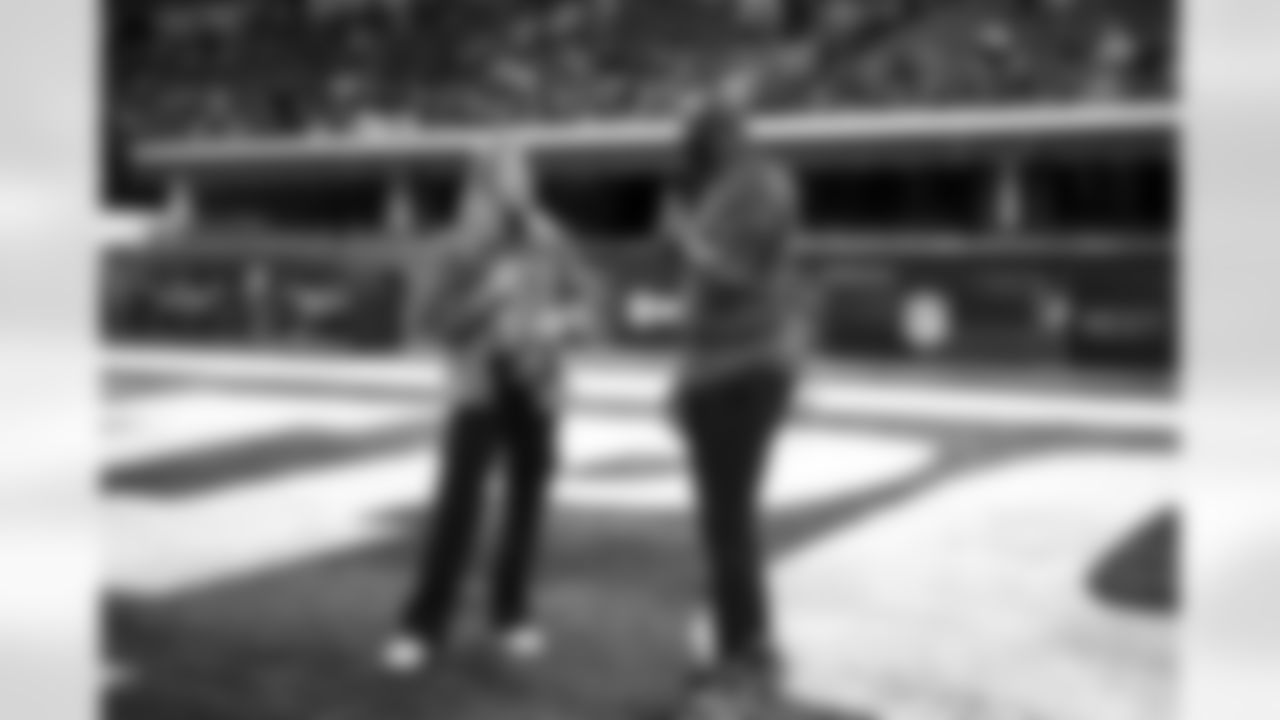 In-stadium host Dannie Rogers speaks on the field with Reggie Wayne during the 2024 NFL Scouting Combine on Sunday, March 3, 2024 in Indianapolis, Indiana. (Kevin Sabitus/NFL)