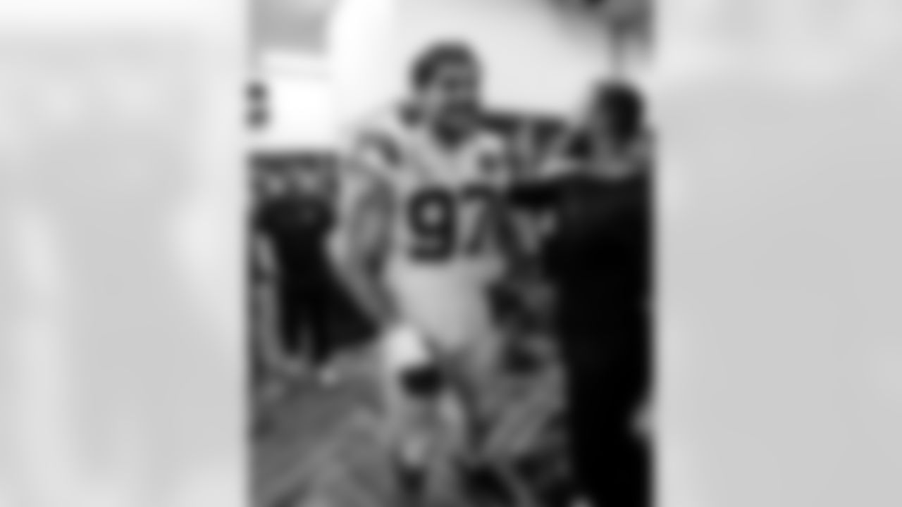 Matt Raich Sr. Assistant - Defensive Line, DE Laiatu Latu #97 and Mike Minnis Director of Sports Performance