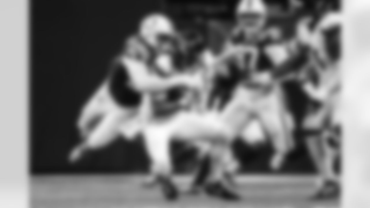 DT Adetomiwa Adebawore #95 and DE Laiatu Latu #97