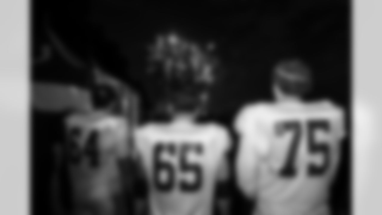 T Marshall Foerner #64, T Jalen Travis #75 and C Mose Vavao #67