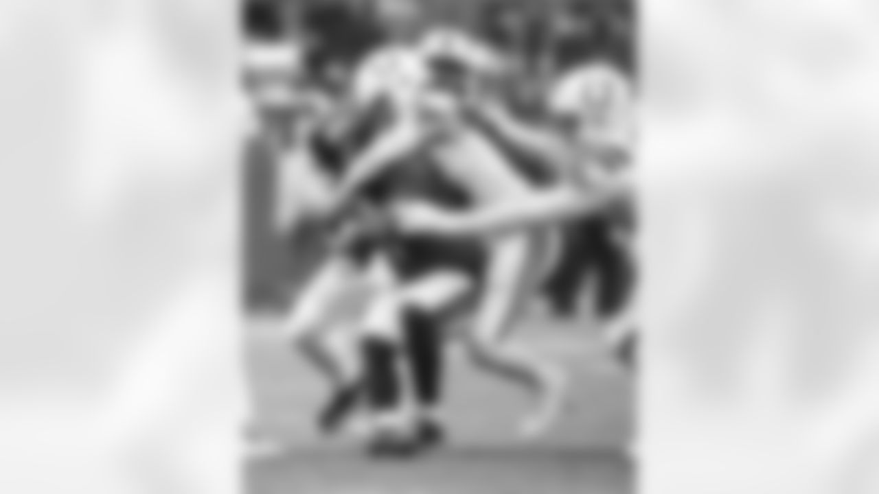 S Camryn Bynum #0, LB Germaine Pratt #53 and DT Adetomiwa Adebawore #95