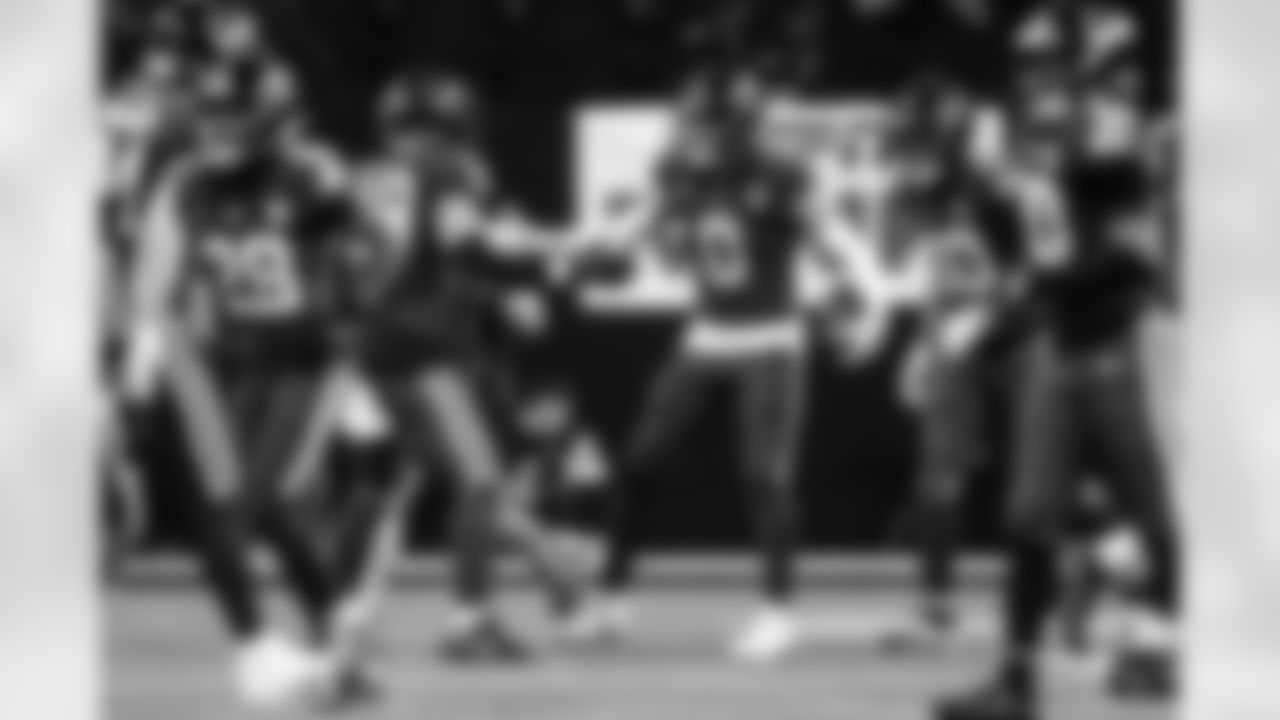 LB Austin Ajiake #58 and S Camryn Bynum #0