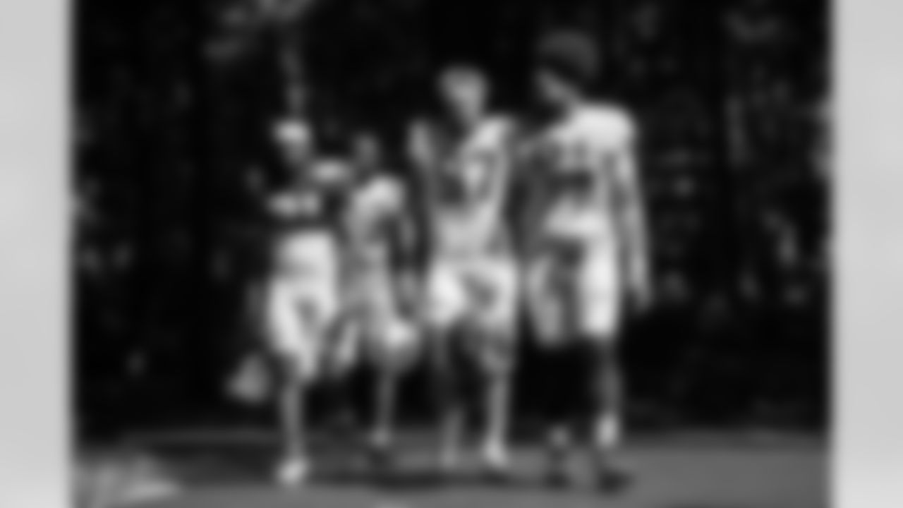 RB Tyler Goodson #31, CB Samuel Womack III #33, DE Laiatu Latu #97 and DE JT Tuimoloau #91