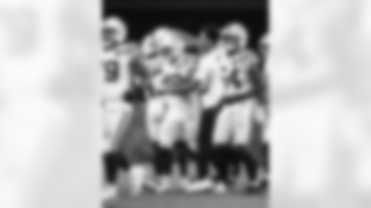 DT Josh Tupou #69, LB Joe Bachie #48, S Camryn Bynum #0 and RB Tyler Goodson #31