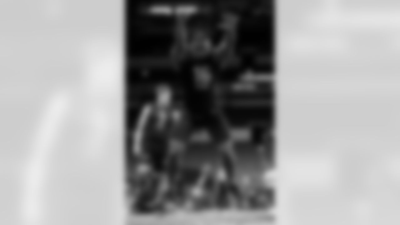 Iowa running back Tyler Goodson leaps in the broad jump at the NFL football scouting combine in Indianapolis, Friday, March 4, 2022. (AP Photo/Charlie Neibergall)