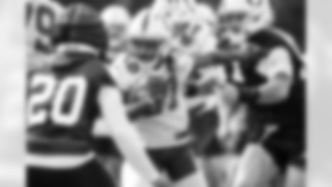 S Nick Cross #20, RB Tyler Goodson #31 and DE Laiatu Latu #97