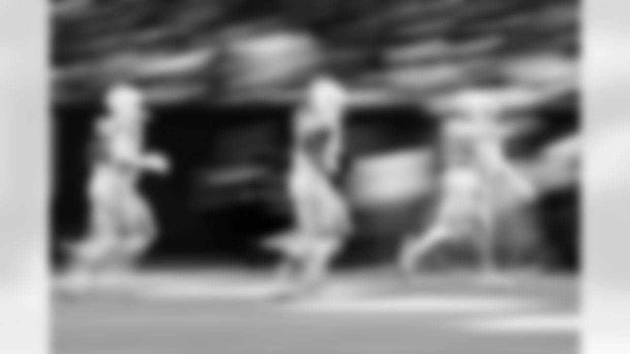 DT Adetomiwa Adebawore #95, DE Tyquan Lewis #94 and DT Adetomiwa Adebawore #95