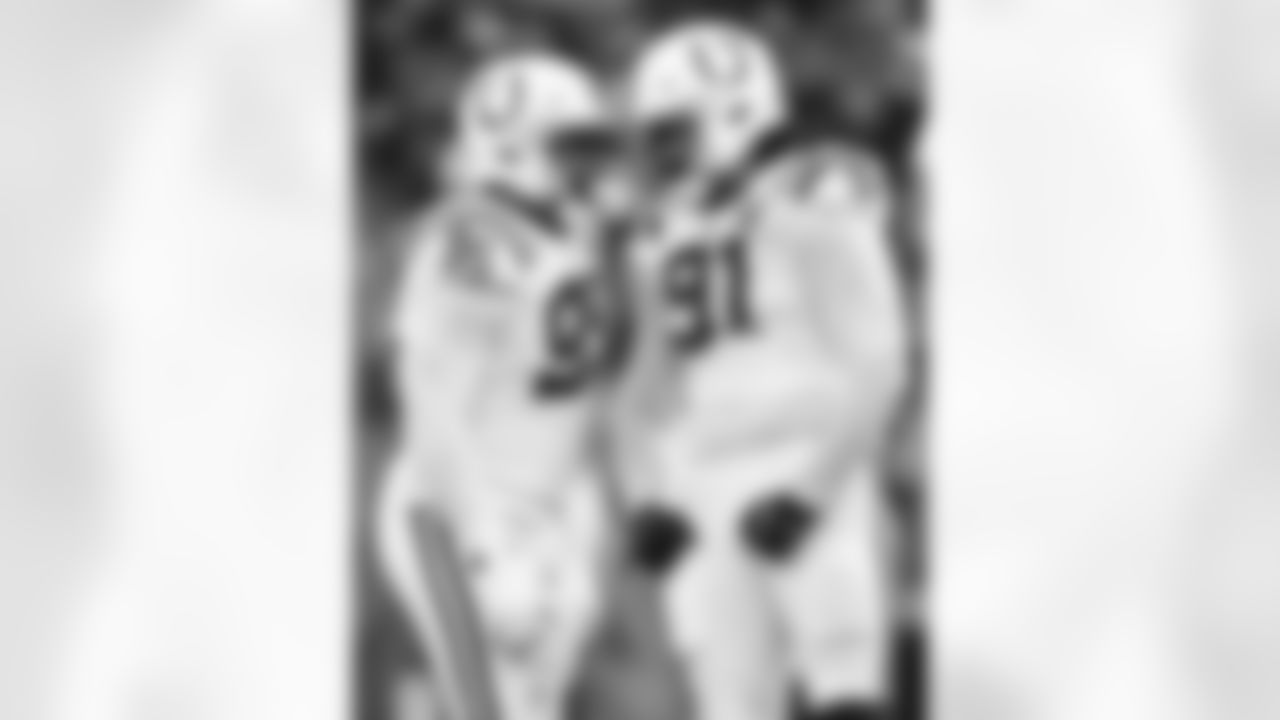 DT Adetomiwa Adebawore #95 and DE JT Tuimoloau #91
