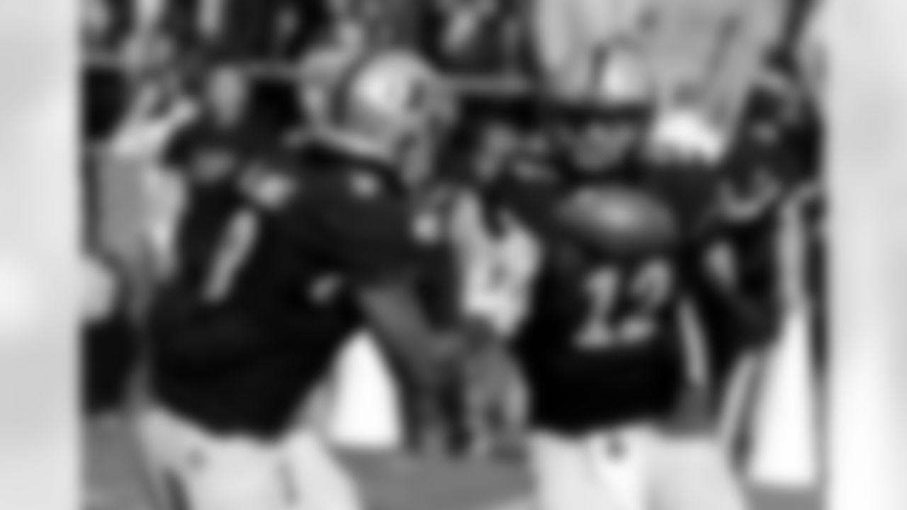 FILE - In this Sept. 19, 2015, file photo, Purdue's Austin Appleby (12) tosses the football to Markell Jones during an NCAA college football game against Virginia Tech in West Lafayette, Ind. Appleby is likely to reclaim the starting job he lost earlier this season if redshirt freshman David Blough can't play against Indiana on Saturday, Nov. 28 after leaving last weekend's game with a concussion. (AP Photo/Darron Cummings, File)