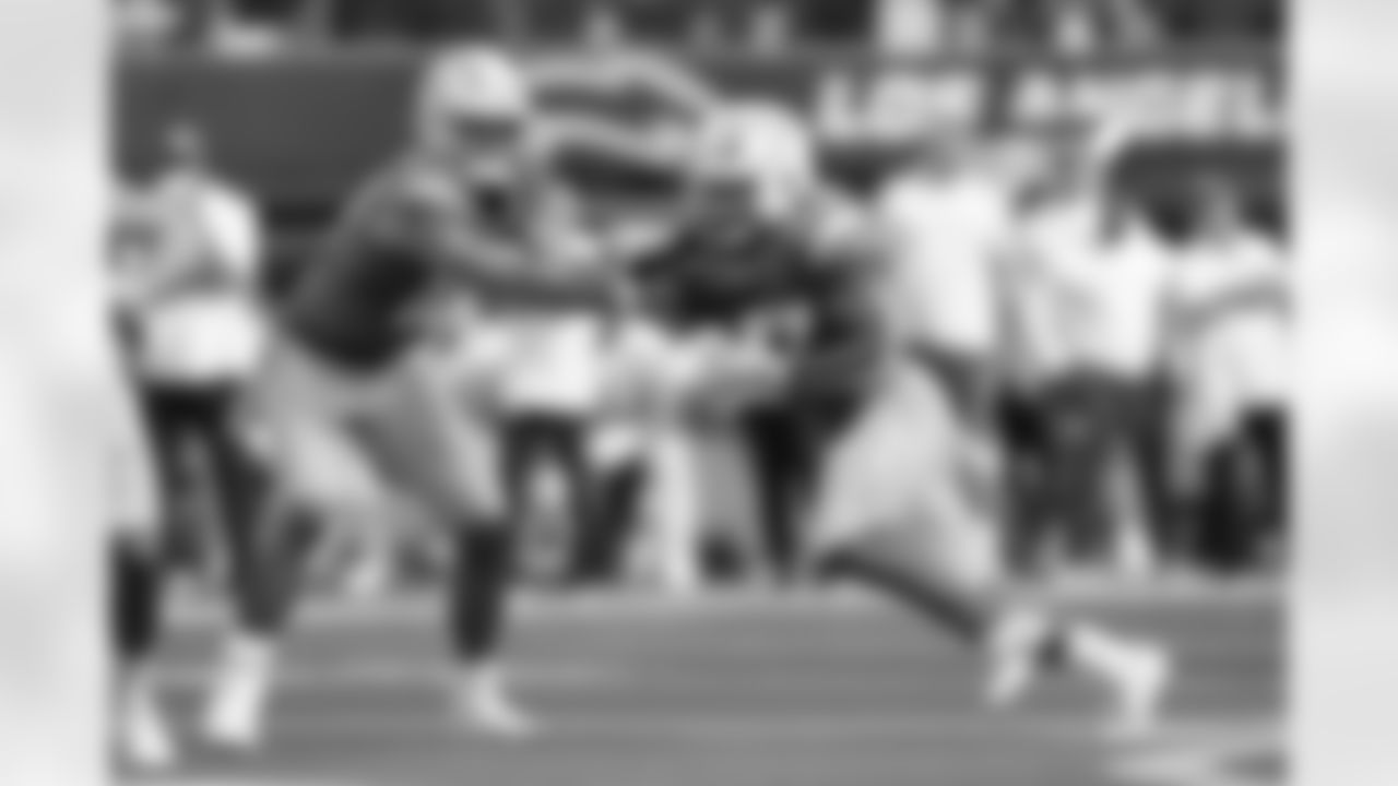 Los Angeles Chargers quarterback Justin Herbert (10) passes to running back J.K. Dobbins (27) during an NFL football game against the Kansas City Chiefs, Sunday, Sept. 29, 2024, in Inglewood, Calif. The Chiefs defeated the Chargers, 17-10. (Ben Liebenberg via AP)